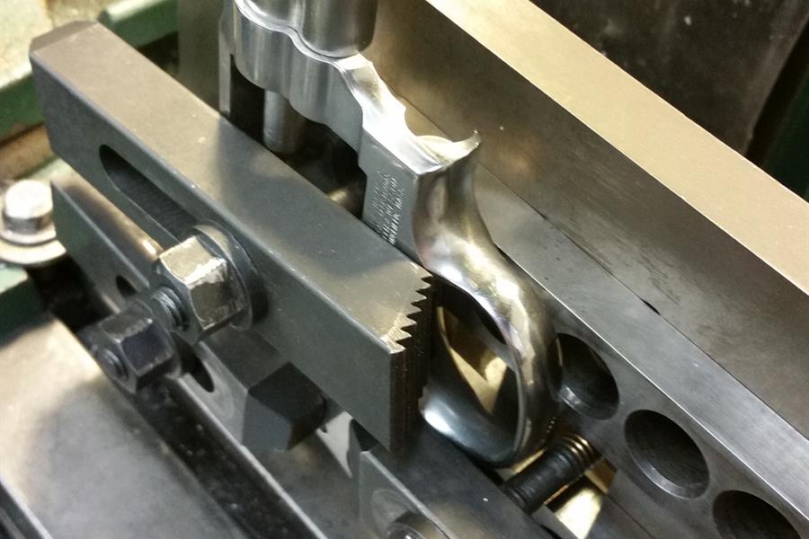 Smith & Wesson revolver frame set up in a milling machine vise at the Defensive Creations shop