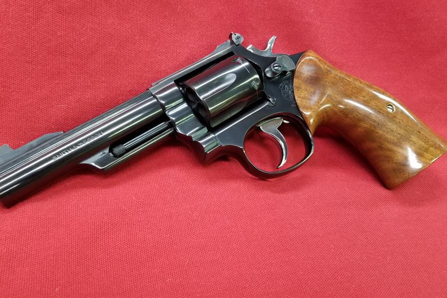Blued Smith & Wesson Model 19 revolver with smooth wood grips